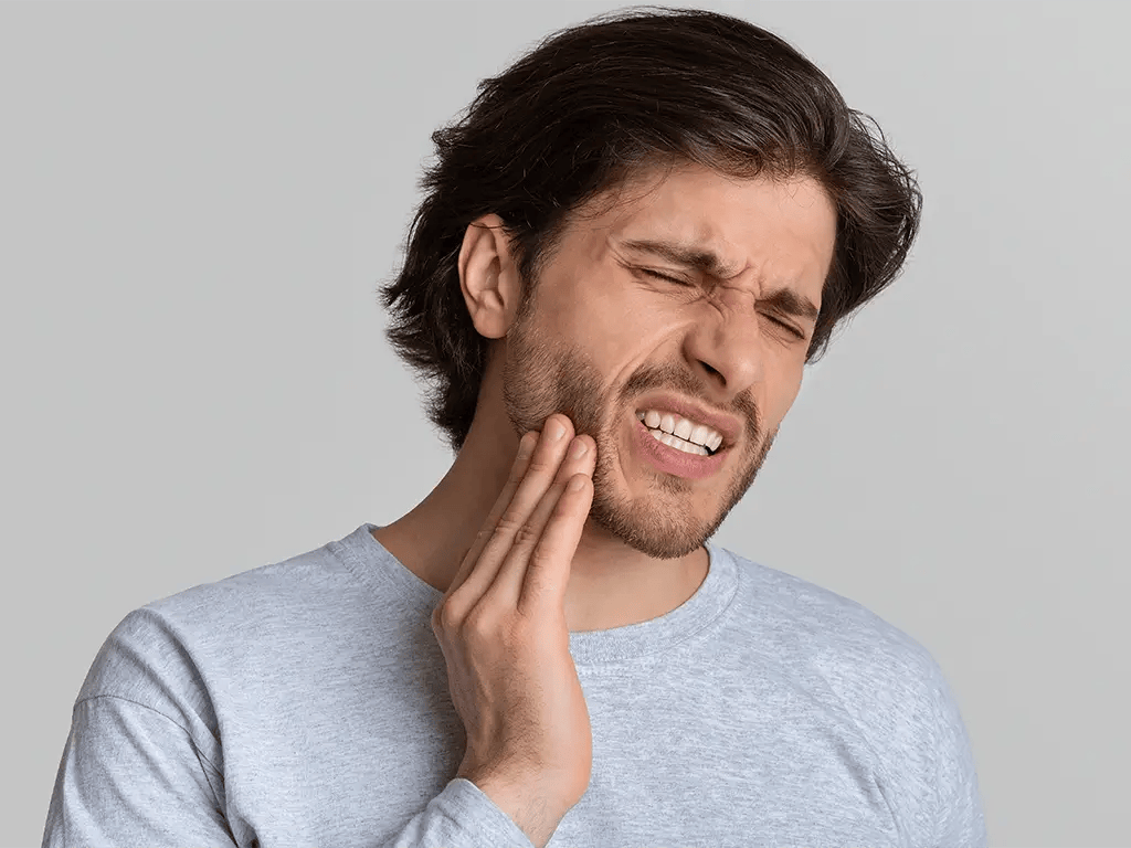 man holding mouth suffering from bad toothache