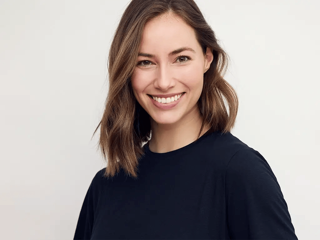 portrait of beautiful natural brunette woman smiling and looking in camera with white teeth